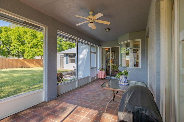 sunroom featuring a ceiling fan