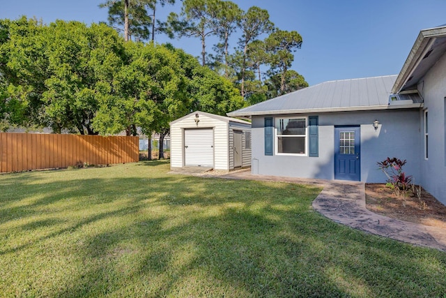 view of yard featuring a shed, an outdoor structure, and fence