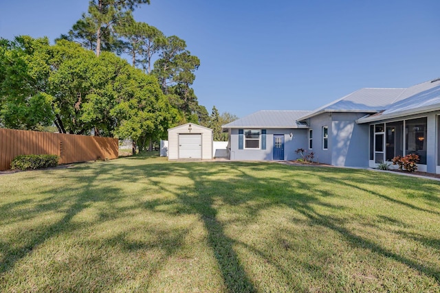 view of yard with a shed, fence, and an outdoor structure