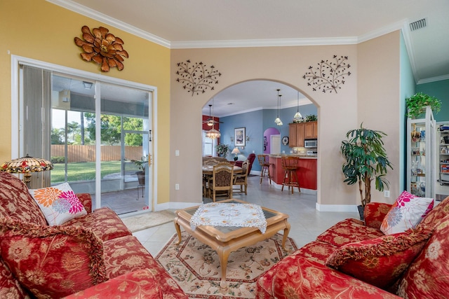 living area featuring arched walkways, crown molding, light tile patterned floors, visible vents, and baseboards