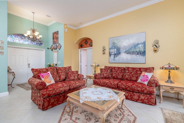 living area featuring arched walkways, ornamental molding, light tile patterned flooring, and an inviting chandelier