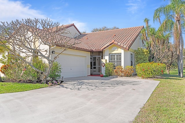 mediterranean / spanish home with a garage and a front lawn