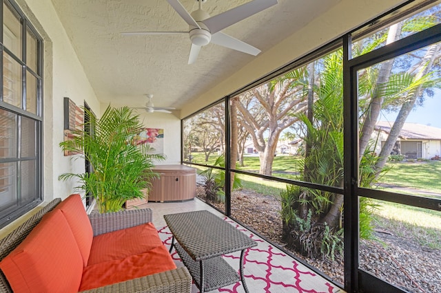 sunroom featuring ceiling fan and a healthy amount of sunlight