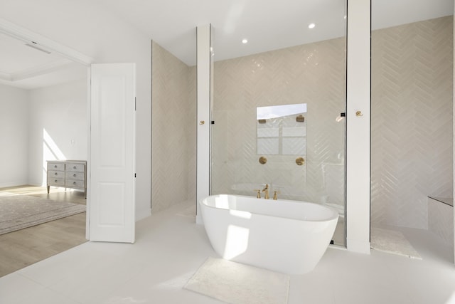 bathroom featuring a freestanding bath, recessed lighting, tile walls, and tile patterned floors