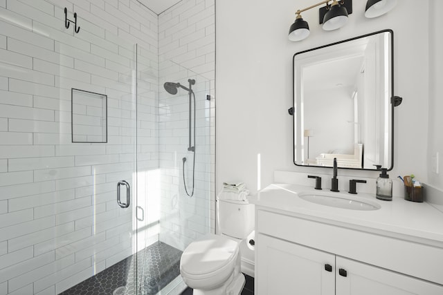 full bathroom featuring toilet, a shower stall, and vanity