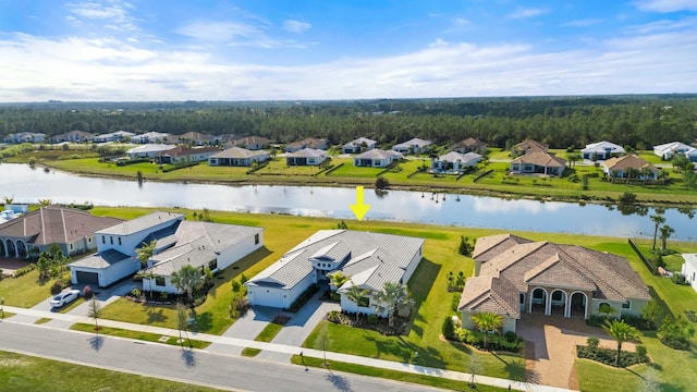 birds eye view of property with a water view and a residential view