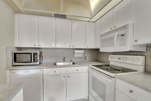 kitchen with tasteful backsplash, sink, white appliances, and white cabinets