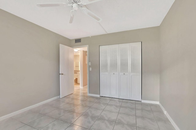 unfurnished bedroom featuring light tile patterned floors, ceiling fan, and a closet