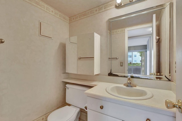 bathroom featuring vanity and toilet