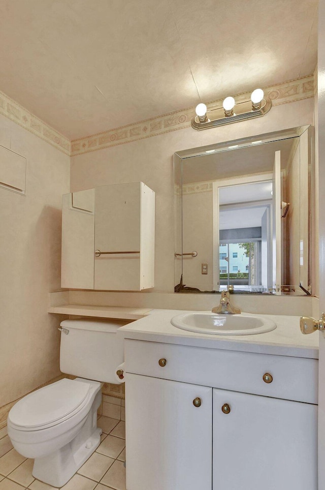 bathroom with tile patterned floors, toilet, and vanity