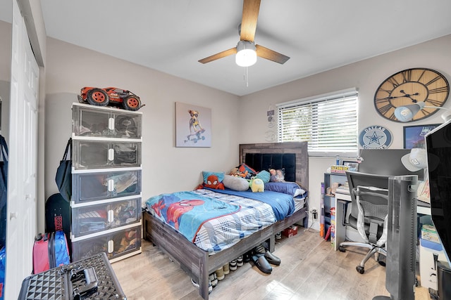 bedroom with ceiling fan and light hardwood / wood-style floors