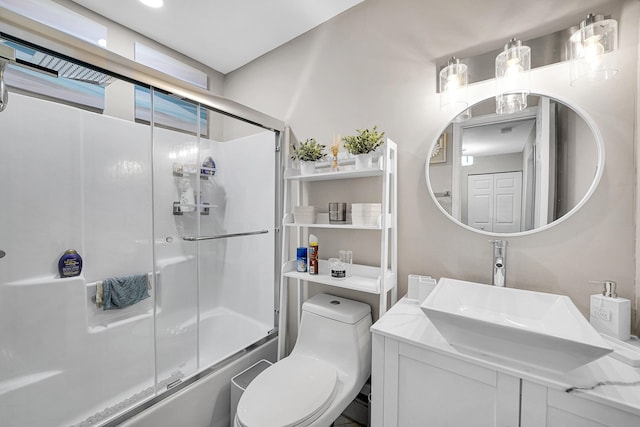 full bathroom featuring toilet, vanity, and shower / bath combination with glass door