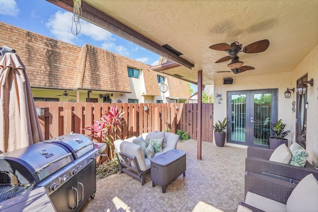 view of patio with area for grilling, an outdoor living space, french doors, and ceiling fan