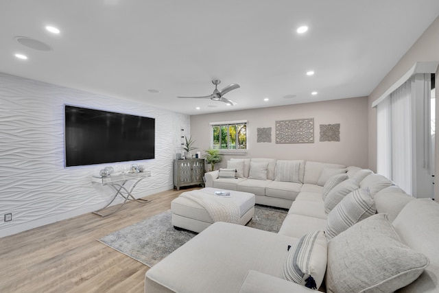 living room featuring ceiling fan and light wood-type flooring