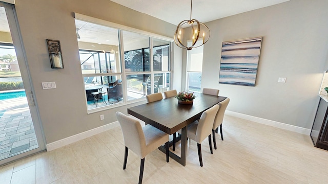 dining area featuring plenty of natural light and a chandelier