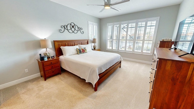 carpeted bedroom with ceiling fan and multiple windows