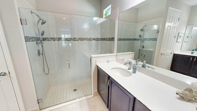 bathroom featuring hardwood / wood-style flooring, vanity, and an enclosed shower