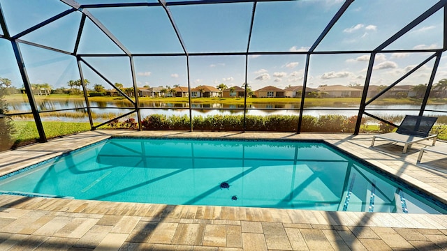 view of swimming pool with a water view, a patio, and glass enclosure