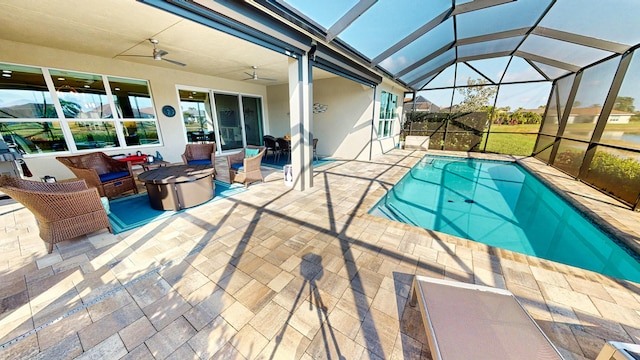 view of swimming pool featuring ceiling fan, a patio, and glass enclosure