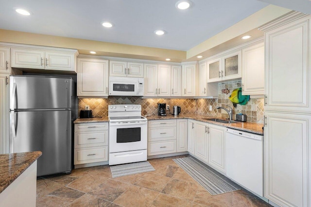 kitchen featuring white cabinetry, white appliances, stone countertops, and sink