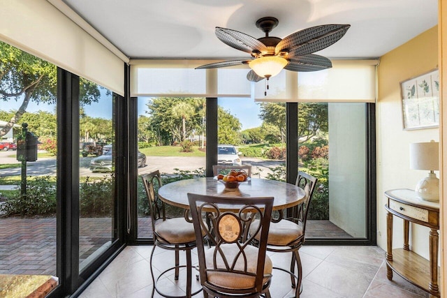 sunroom / solarium featuring a wealth of natural light and ceiling fan