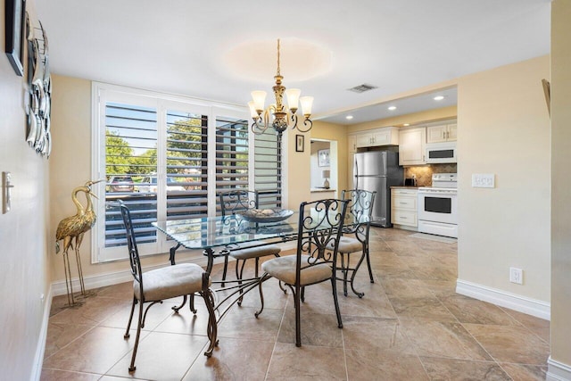 dining area featuring a notable chandelier