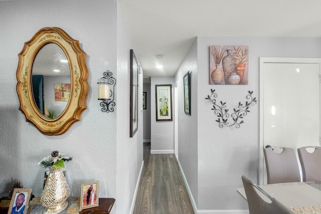 hallway with dark hardwood / wood-style flooring