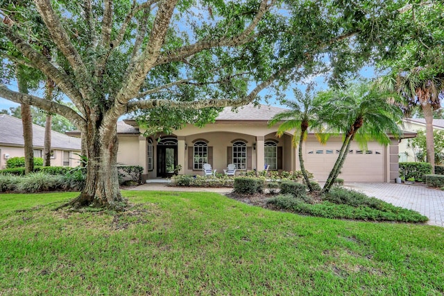 view of front of home with a garage and a front yard