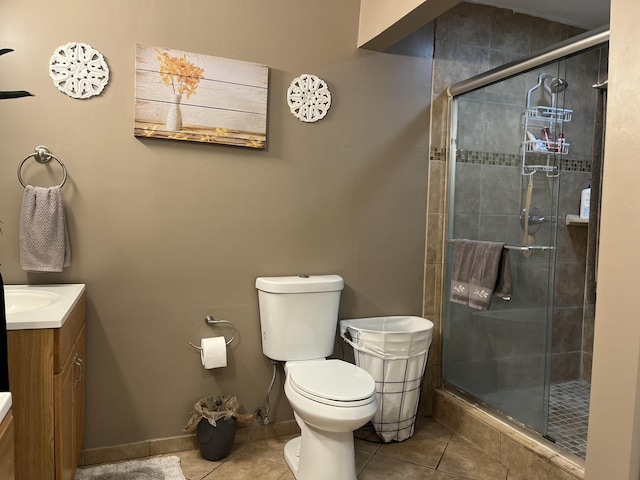 bathroom with walk in shower, vanity, toilet, and tile patterned flooring