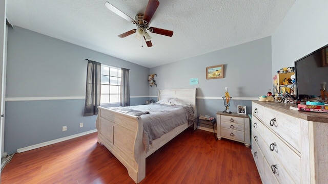 bedroom featuring ceiling fan, dark hardwood / wood-style floors, and a textured ceiling