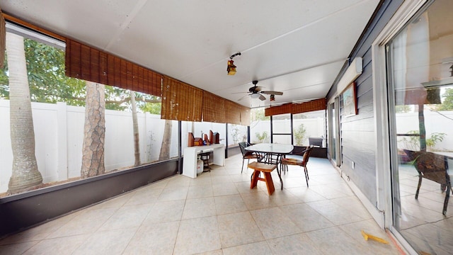 sunroom / solarium featuring ceiling fan