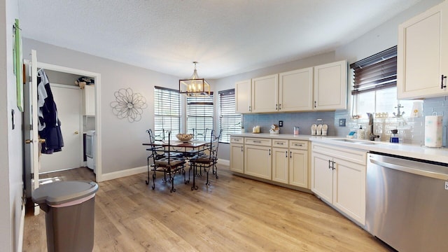 kitchen with sink, tasteful backsplash, hanging light fixtures, light hardwood / wood-style flooring, and dishwasher