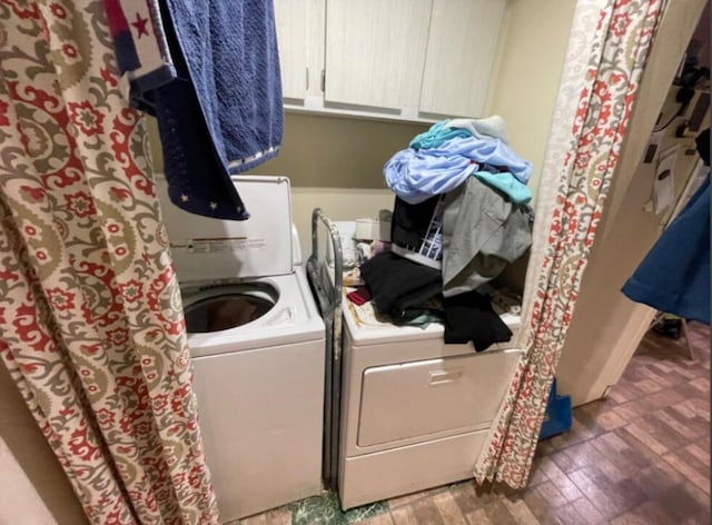 washroom with cabinets, dark hardwood / wood-style floors, and separate washer and dryer