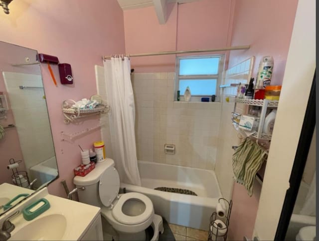 full bathroom with shower / bath combo, sink, tile patterned floors, and toilet