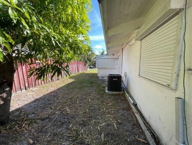 view of yard featuring central air condition unit