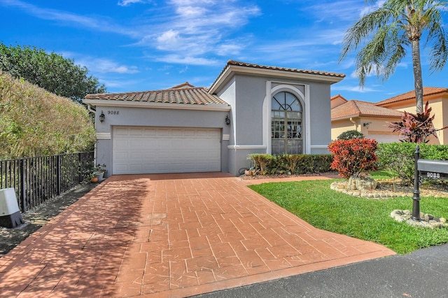 mediterranean / spanish-style home with a garage