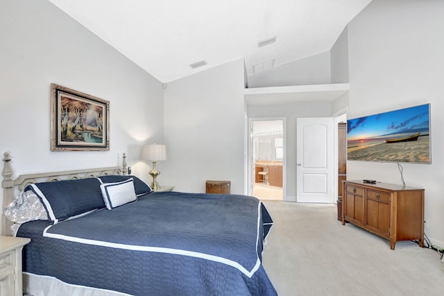 bedroom featuring vaulted ceiling, light carpet, and ensuite bathroom