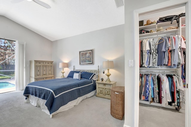 bedroom featuring lofted ceiling, access to outside, light carpet, and a closet