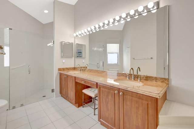 bathroom with vanity, a shower with shower door, tile patterned floors, and toilet