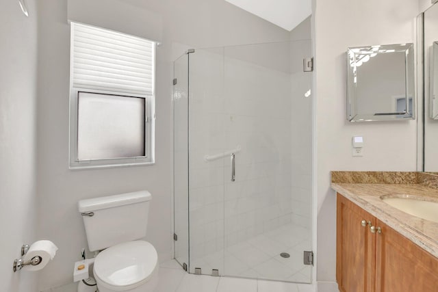 bathroom featuring vanity, a shower with shower door, and toilet