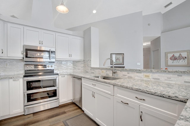 kitchen with sink, white cabinets, and appliances with stainless steel finishes