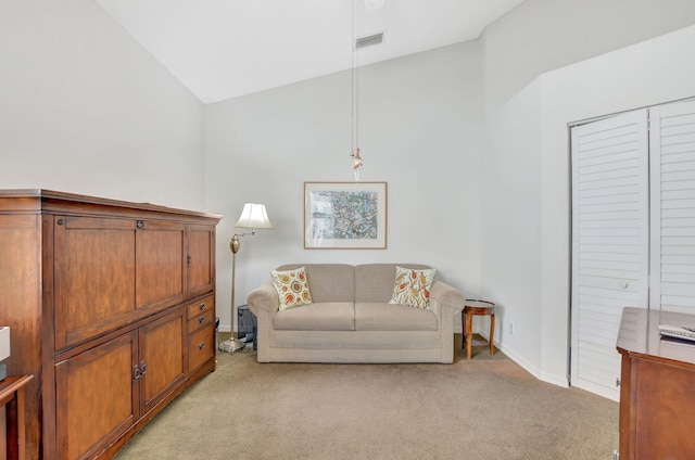 living area featuring light carpet and vaulted ceiling