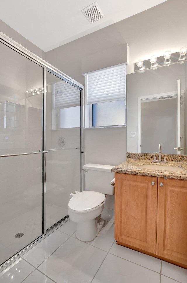 bathroom with walk in shower, vanity, and toilet