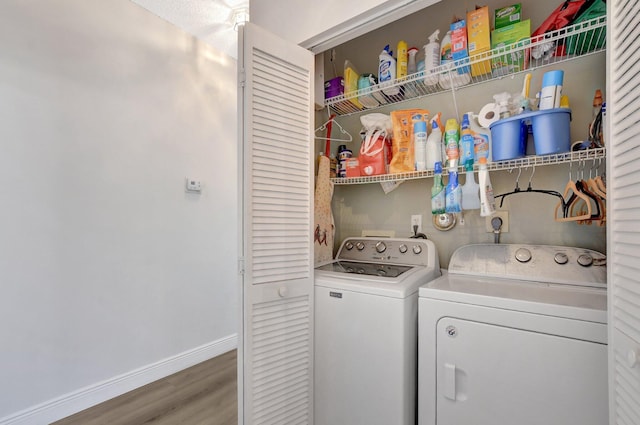 washroom featuring wood-type flooring and washer and dryer