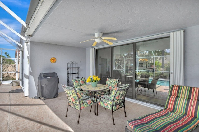 view of patio featuring ceiling fan, a lanai, and grilling area