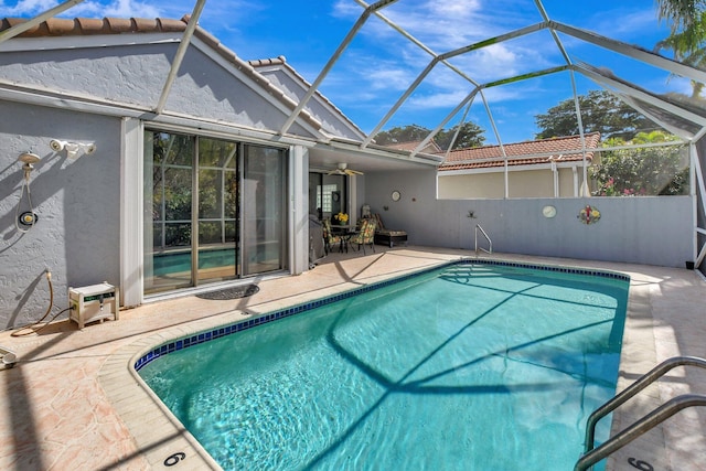 view of swimming pool with a lanai and a patio area