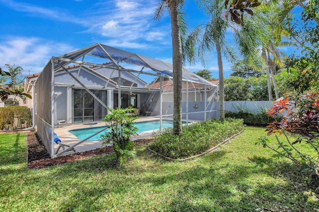 exterior space with a fenced in pool, a lanai, and a yard