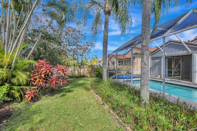 view of yard featuring a fenced in pool and a lanai