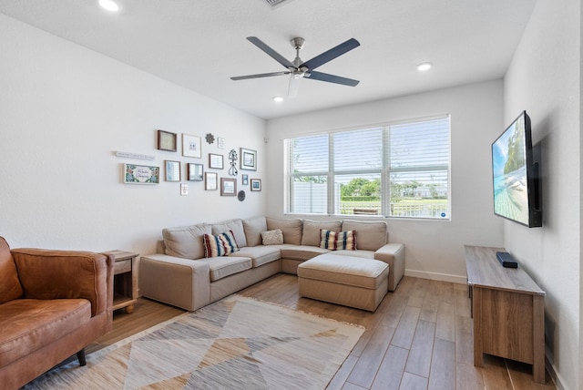 living room with ceiling fan and light hardwood / wood-style floors