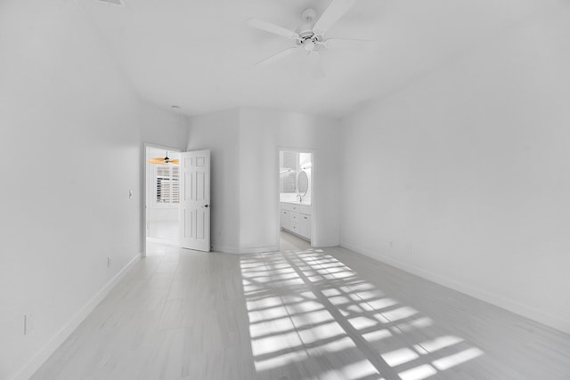 unfurnished bedroom featuring ensuite bathroom and ceiling fan